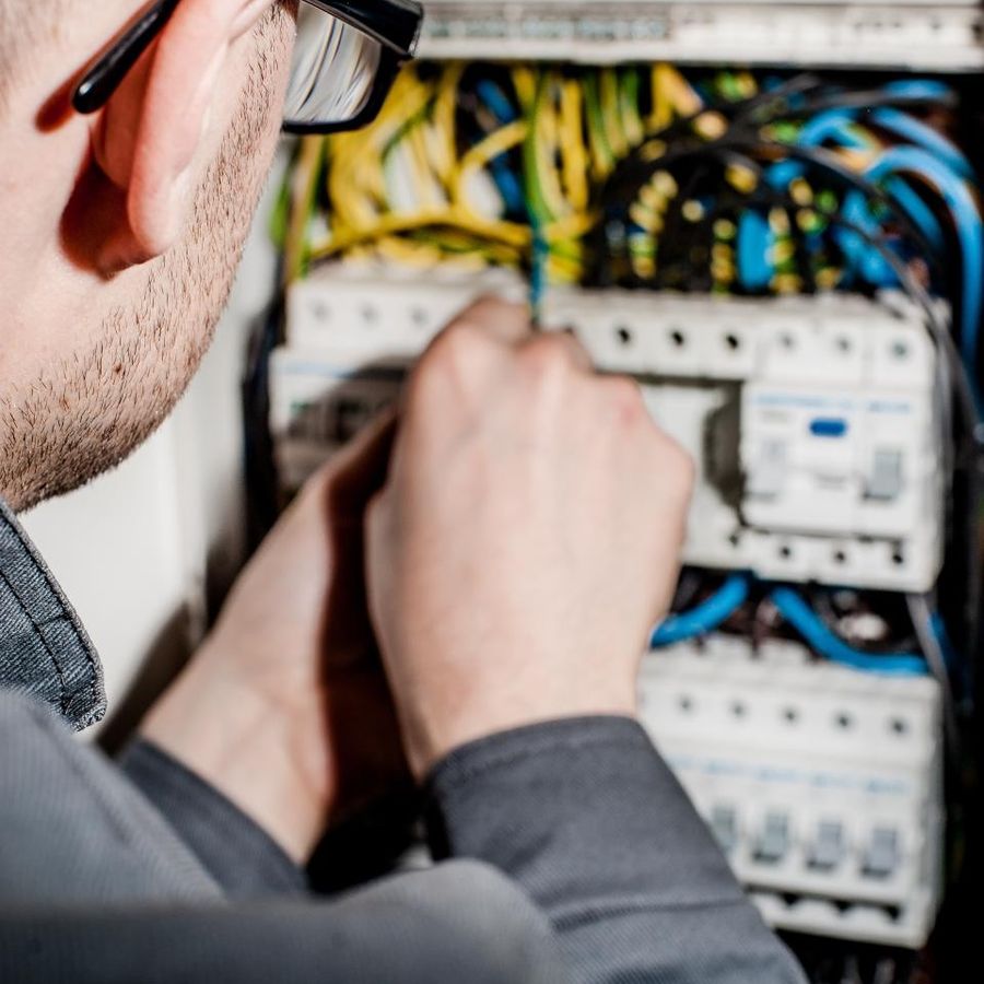 Electrician wiring an electrical panel