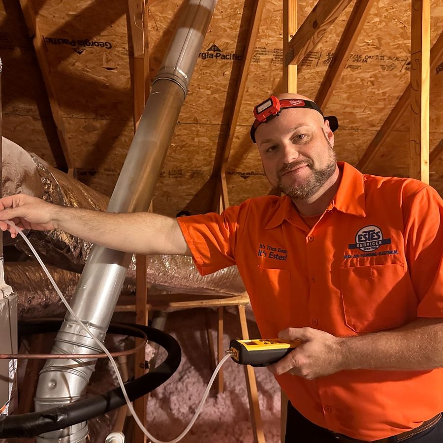 HVAC technician servicing a heating and cooling system
