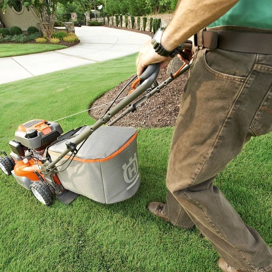 Landscaper mowing a lawn